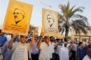 Anti-government protesters hold up photos of political prisoner Ebrahim Shareef which read, "Release all the political Detainees" march during a rally organized by Bahrain's main opposition party Al Wefaq on Budaiya highway west of Manama
