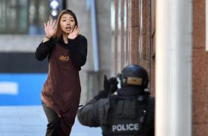 One of the hostages runs towards police after leaving …