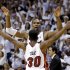 Miami Heat's Chris Bosh and Norris Cole (30) celebrate after the Heat defeated the Chicago Bulls 94-91 in Game 5 of an NBA basketball Eastern Conference semifinal, Wednesday, May 15, 2013, in Miami. The win sent the Heat to the conference finals. (AP Photo/Wilfredo Lee)