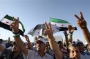 People shout slogans in support of Colonel Hamada during a demonstration against Syria's President al-Assad in Amman