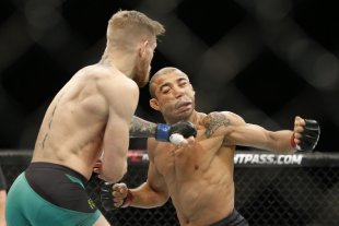Conor McGregor knocks out Jose Aldo with a left hook at UFC 194. (AP)