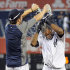 New York Yankees' Nick Swisher, left, douses teammate Eduardo Nunez with water after they defeated the Oakland Athletics 10-9 during the 14th inning of a baseball game on Saturday, Sept. 22, 2012, at Yankee Stadium in New York. (AP Photo/Bill Kostroun)
