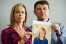 Kate and Gerry McCann pose with an artist's impression of how their missing daughter Madeleine might look now, at a press conference in central London on May 2, 2012