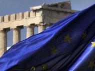 Columns of the Parthenon temple are seen behind an EU flag in Athens in November