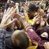 Minnesota's Rodney Williams Jr., center, is surrounded by fans as he leaves the court after defeating Indiana 77-73 in an NCAA college basketball game, Tuesday, Feb. 26, 2013, in Minneapolis. (AP Photo/Tom Olmscheid)