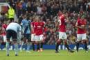 Manchester United players including Wayne Rooney, centre left, react after conceding a goal to West Ham United during their English Premier League soccer match at Old Trafford Stadium, Manchester, England, Saturday Sept. 27, 2014. (AP Photo/Jon Super)