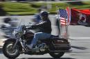 A motorcycle rider flies the American and POW-MIA flags as he rides with hundreds of thousands of fellow motorcyclists in Fairfax