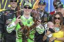 Kyle Busch holds the Loudon lobster trophy in Victory Lane, as his wife, right, Samantha holding son Brexton looks on, after winning the NASCAR Sprint Cup series auto race at New Hampshire Motor Speedway, Loudon, N.H., Sunday, July 19, 2015 (AP Photo/Cheryl Senter)