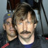 FILE - In this Tuesday Nov. 16, 2010 file photo provided by the Drug Enforcement Administration, Russian arms trafficking suspect Viktor Bout, is seen in U.S. custody after being flown from Bangkok to New York in a chartered U.S. plane. Records found in Moammar Gadhafi's former intelligence headquarters in Tripoli show that British officials apparently warned the Libyan regime in 2003 about its dealings with Bout, who was convicted last week in New York on federal conspiracy charges. (AP Photo/Drug Enforcement Administration, File)