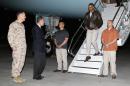 U.S. Marine General Joseph Dunford and U.S. Ambassador to Afghanistan James Cunningham greet U.S. President Barack Obama as he arrives aboard Air Force One at Bagram Air Base in Kabul
