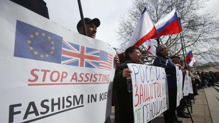 Pro-Russia demonstrators hold Russian and C