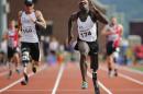 In this Thursday, June 16, 2016 photo, William Reynolds, a 2002 graduate of the U.S. Military Academy, competes in the 100-meter race at the Warrior Games in West Point, N.Y. Reynolds breezed past the finish line first in his 100-meter race at West Point, down the hill from where he once marched as a cadet and a dozen years since the attack in Iraq that cost him part of his left leg. (AP Photo/Mike Groll)