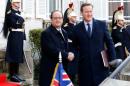 French President Francois Hollande and Britain's Prime Minister David Cameron arrive to attend a Franco-British summit in Amiens