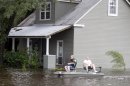 Two men use small boat to travel though flooded streets Thursday, Aug. 30, 2012, in Slidell, La. Isaac's maximum sustained winds had decreased to 45 mph and the National Hurricane Center said it was expected to become a tropical depression by Thursday night. (AP Photo/John Bazemore)