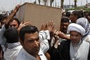 Family members of Diaa Mutashar al-Issawi carry his coffin during his funeral in Basra, Iraq's second-largest city, 340 miles (550 kilometers) southeast of Baghdad, Iraq, Monday, May 6, 2013. The Iraqi Shiite fighter's body was collected Monday morning at a border crossing with Iran, then carried through the streets of this southern Iraqi city as mourners vowed a similar sacrifice to protect a revered shrine in Syria. (AP Photo/ Nabil Al-Jurani)