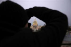 A tourist takes a picture of the the Capitol building&nbsp;&hellip;