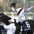 Mike Smith celebrates atop Royal Delta after his victory in the running of the Breeders' Cup Ladies Classic thoroughbred horse race at Santa Anita Park in Arcadia