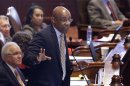 Illinois Sen. Kwame Raoul, D-Chicago, argues concealed carry gun legislation while on the Senate floor during session at the Illinois State Capitol Tuesday, July 9, 2013, in Springfield, Ill. Illinois became the last state in the nation to allow public possession of concealed guns as lawmakers rushed Tuesday to finalize a proposal ahead of a federal court's deadline. (AP Photo/Seth Perlman)