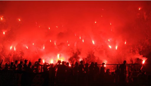 Fans of Tunisian's Esperance Sportive de Tunis light flares during their African Champions League soccer match against Tunisian's Etoile Sportive du Sahel at the Rades stadium in Tunis