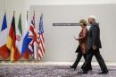 EU foreign policy chief Catherine Ashton (L) and Iranian Foreign Minister Mohammad Javad Zarif arrive for a statement on early November 24, 2013 in Geneva
