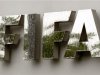 Water flows over the FIFA logo in front of the FIFA headquarters during heavy rainfall in Zurich
