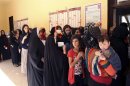 Iraqi Kurds line up at a polling station before voting during the regional parliamentary elections at a polling station in Arbil