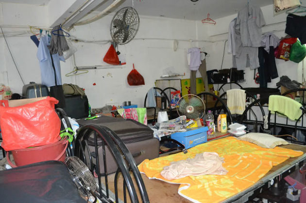 Starved of space, foreign workers make do with makeshift sleeping areas. (Photo: Andrew Loh)