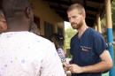 Handout photo of Dr. Kent Brantly speaking with colleagues at the case management center on the campus of ELWA Hospital in Monrovia