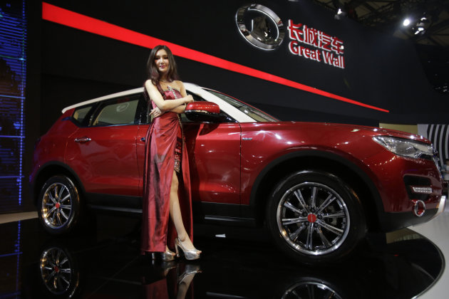 <p> A model poses with Great Wall H7 SUV at the Shanghai International Automobile Industry Exhibition (AUTO Shanghai) media day in Shanghai, China Saturday, April 20, 2013. China's most successful SUV producer, Great Wall Motor Co., is coming out with a model that offers the room of a luxury SUV at a mid-range price. The Chinese brand, which exports SUVs to 80 countries, unveiled the H7 and its sister sport model, the H6, on Saturday ahead of the Shanghai auto show. Great Wall is one exception to the trend of independent Chinese brands struggling against foreign competition in their home market.(AP Photo/Eugene Hoshiko)