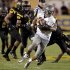 Oregon quarterback Marcus Mariota (8) scrambles for yardage as he is pursued by Arizona State defenders during the first half of an NCAA college football game, Thursday, Oct. 18, 2012, in Tempe, Ariz.  (AP Photo/Matt York)