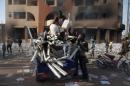People load goods looted from a building, which according to locals, belongs to Francois Compaore, the younger brother of Burkina Faso's President Blaise Compaore, in Ouagadougou