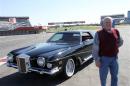Automobile restorer Hollifield poses with Presley's 1973 Stutz Blackhawk III at Charlotte Motor Speedway
