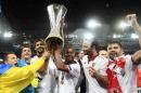Sevilla's team players celebrates the victory with the trophy after the soccer Europa League final between England's Liverpool FC and Spain's Sevilla Futbol Club at the St. Jakob-Park stadium in Basel, Switzerland, Wednesday, May 18, 2016. (Jean-Christophe Bott/Keystone via AP)