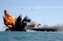 Iran's elite Revolutionary Guard attack a vessel during a military drill in the Strait of Hormuz, on February 25, 2015