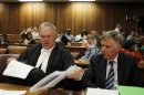 Pistorius's lawyers Roux and Webber prepare documents before the start of the application to appeal some of his bail conditions at a Pretoria court in Pretoria
