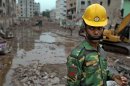 A Bangladeshi soldier stands at the site where a Bangladesh garment-factory building collapsed on April 24 in Savar, near Dhaka, Bangladesh, Monday, May 13, 2013.Nearly three weeks after the building collapsed, the search for the dead ended Monday at the site of the worst disaster in the history of the global garment industry. (AP Photo/A.M. Ahad)