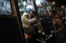 Migrants enter a bus, which is supposed to leave to Austria and Germany, at the Keleti trainstation in Budapest
