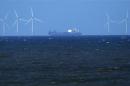 A ship sails past the Barrow offshore wind farm off the coast of Cumbria