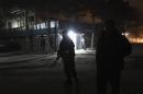 Afghan police officers keep watch at the scene of an explosion in Kabul