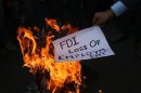 An activist of Shiv Sena burns a pamphlet during a protest against FDI in retail sector in Jammu