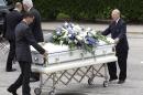 One of six caskets is moved into The Church of Jesus Christ of Latter-day Saints for a funeral service for members of the Stay family Wednesday, July 16, 2014, in Houston. Slaying victims Stephen Stay, 39, his 34-year-old wife, Katie, and their four youngest children were shot to death last week in their suburban Houston home. The oldest child Cassidy, 15, survived the attack by playing dead, called police and identified her uncle, 33-year-old Ronald Lee Haskell, as the gunman. Funeral services will be held later today. (AP Photo/David J. Phillip)