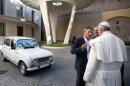 Pope Francis next to a white Renault 4L offered by Father Don Renzo Zocca on September 7, 2013 at the Vatican