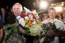 Statkevich, former opposition presidential candidate in 2010 campaign, is seen with his wife Adamovich as he arrives after his release from prison in Minsk