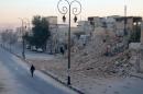 A man walks past a damaged site in the rebel-held besieged Qadi Askar neighbourhood of Aleppo