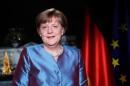 German Chancellor Angela Merkel poses for photographs after the television recording of her annual New Year's speech at the Chancellery in Berlin