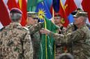 U.S. General John Campbell, commander of NATO-led International Security Assistance Force (ISAF), folds the flag of the ISAF during the change of mission ceremony in Kabul