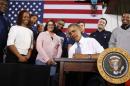 U.S. President Barack Obama signs a Presidential Memorandum at General Electric's Waukesha Gas Engines facility in Wisconsin