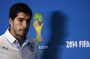 Uruguay's national soccer team player Luis Suarez arrives at a news conference prior a training session at the Dunas Arena soccer stadium in Natal