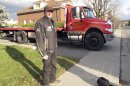 In this Nov. 13, 2012 photo, Nicholas Dostie stands in front of his tow-truck in Magog, Quebec, that he said he used to tow a van in which about a dozen men, women and children entered Canada illegally from the United States and applied for political asylum. Canadian immigration officials on Wednesday, Dec. 5, 2012 said a Romanian smuggling ring has been bringing Gypsies into the U.S. through Mexico in order for them to eventually gain asylum in Canada. (AP Photo/Wilson Ring)