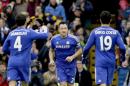 Chelsea's captain John Terry, center, celebrates scoring his side's first goal with his teammates Cesc Fabregas, left, and Diego Costa during the English Premier League soccer match between Chelsea and West Ham at Stamford Bridge stadium in London, Friday, Dec. 26, 2014. (AP Photo/Matt Dunham)